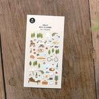 Sheet of decorative stickers with illustrations on a wooden surface