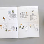 Open book with illustrations and text on a white background