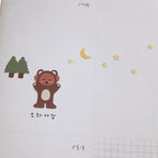 Illustration of a bear with trees, moon, and stars on a white background