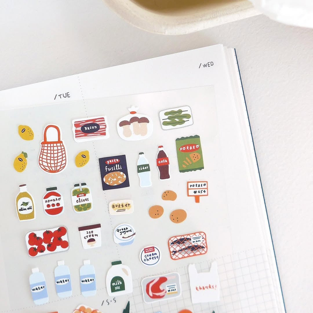 Collection of colorful stickers on a planner page with a white background