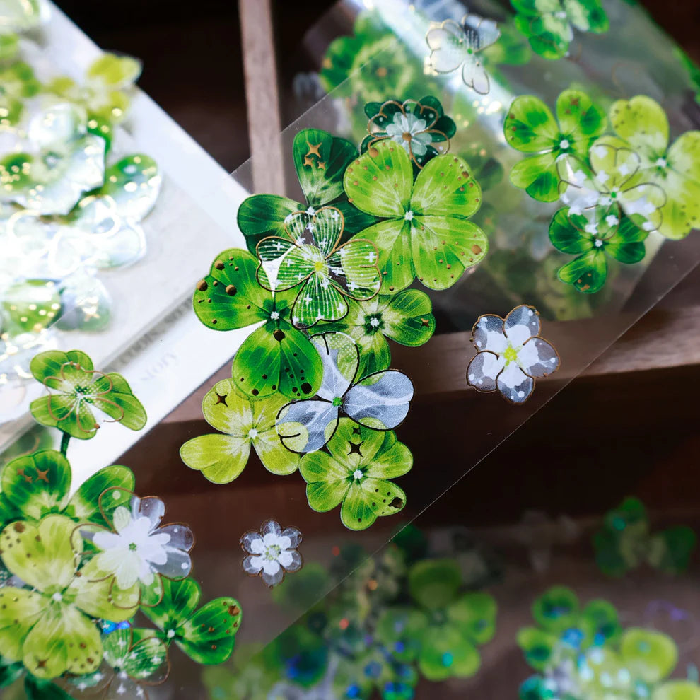 Green floral and butterfly stickers on a clear sheet