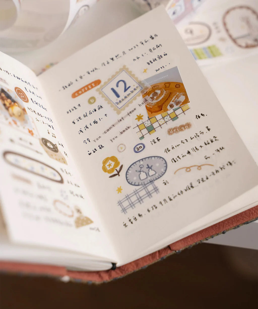 Open notebook decorated with Sunset Washi Tape illustrations and text on a white background