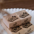 Wooden stamps with illustrations and 'Eileen Tai Studio' branding on a blurred background