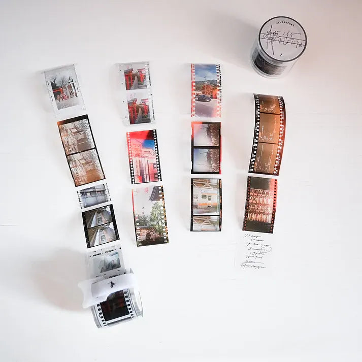 Film strips with printed photos on a white surface