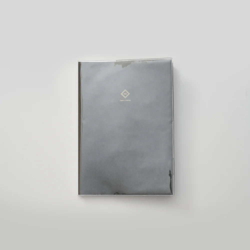 Gray notebook with a logo on a light gray background