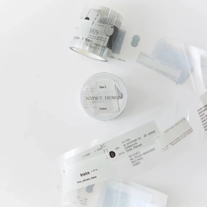 L Ticket Glossy PET Tape styled with a small container, tape roll and printed pieces on white