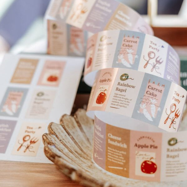 Roll of Tea Party Label Sticker Tape food-style labels displayed on a wooden surface