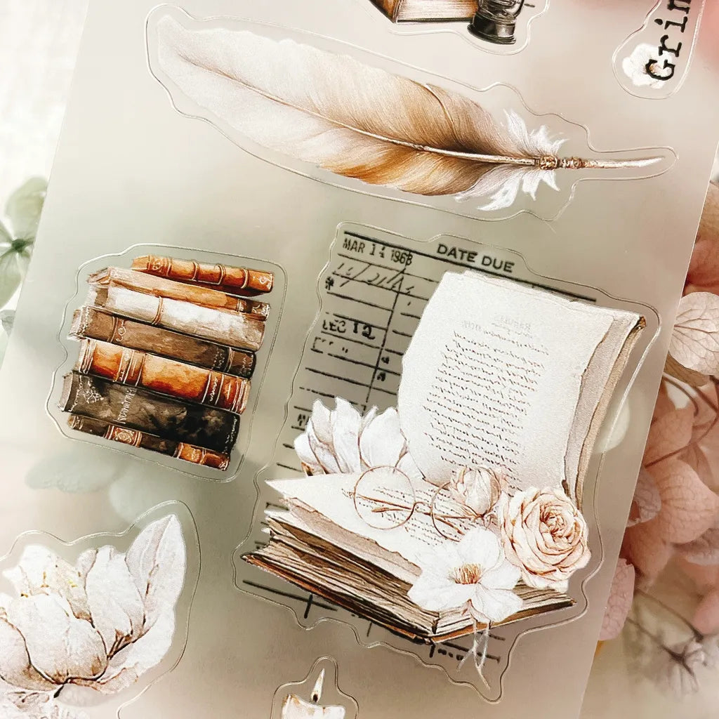 The Cosy Chapter PET Tape books, feather and flower designs styled on a light background