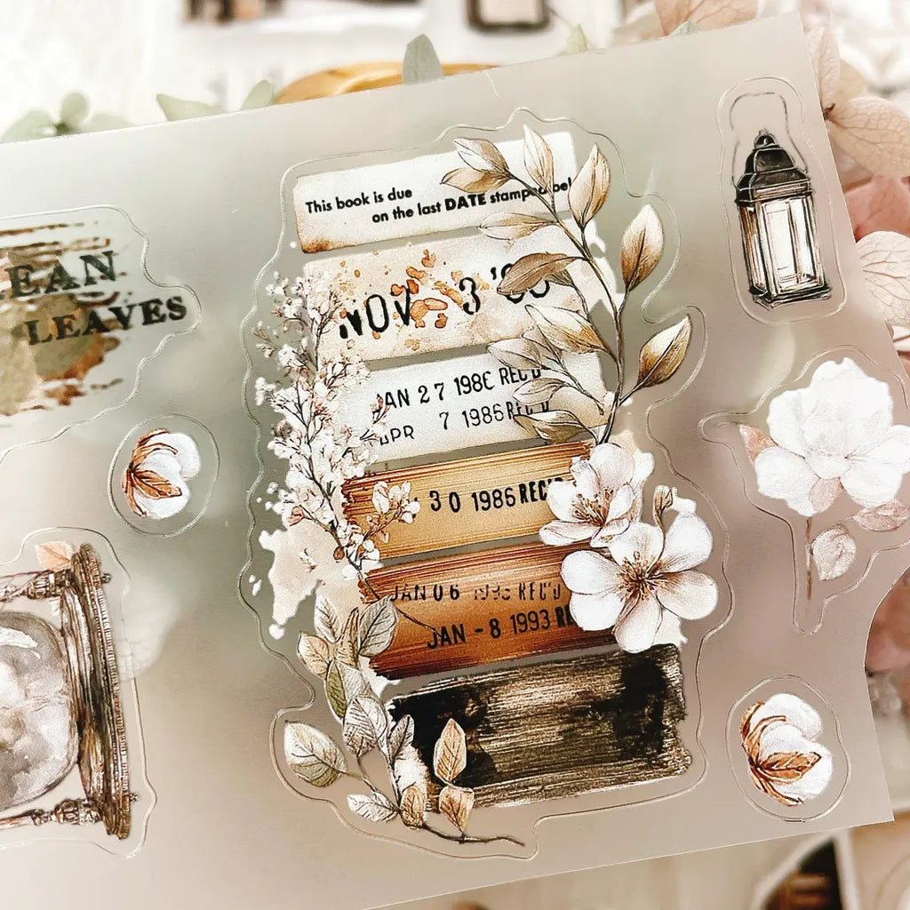 The Cosy Chapter PET Tape styled with a decorative stamp set of florals and text on white