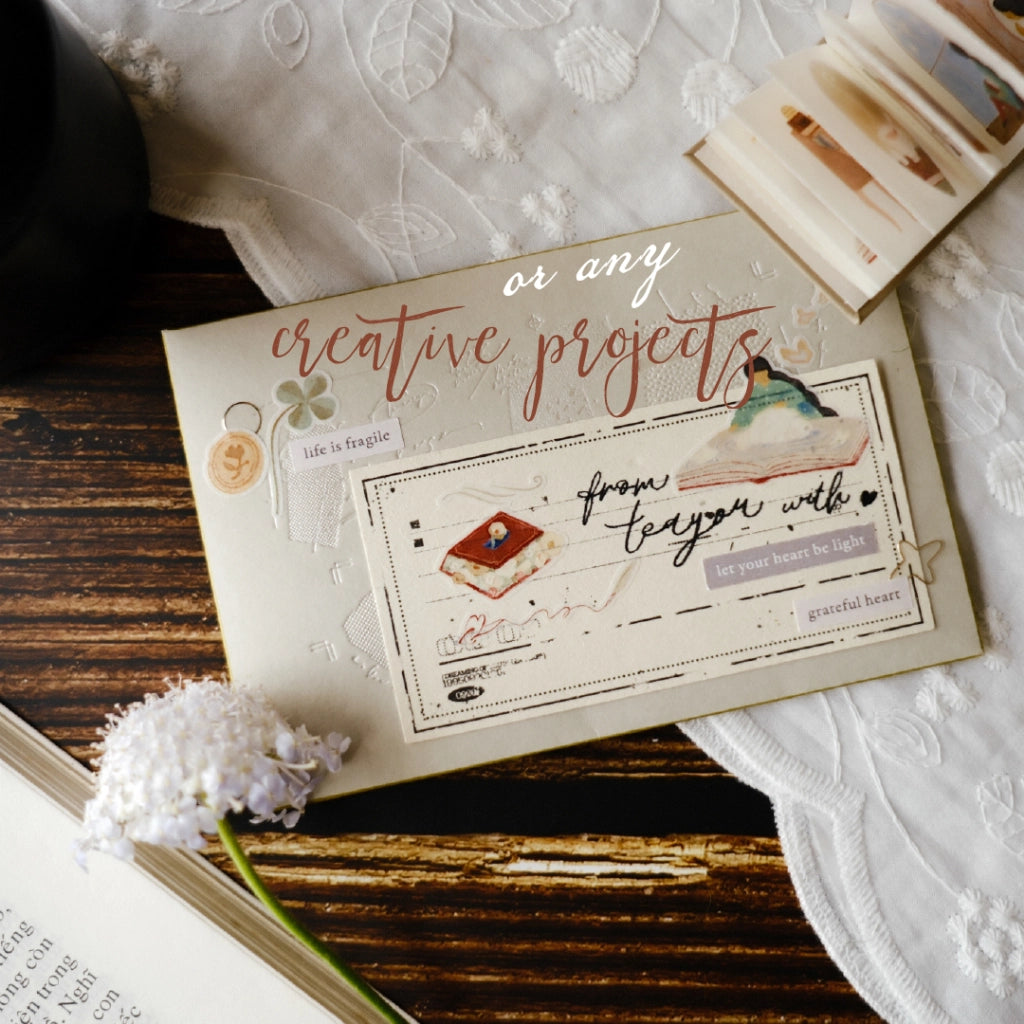 Card with decorative text and illustrations on a wooden surface with lace fabric