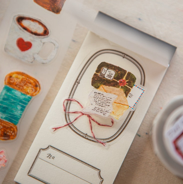 Card with illustration of a cake and envelope on a textured surface