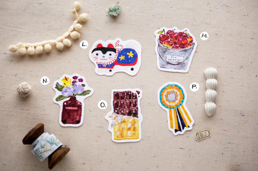 Set of colorful stickers on a wooden surface with decorative elements.