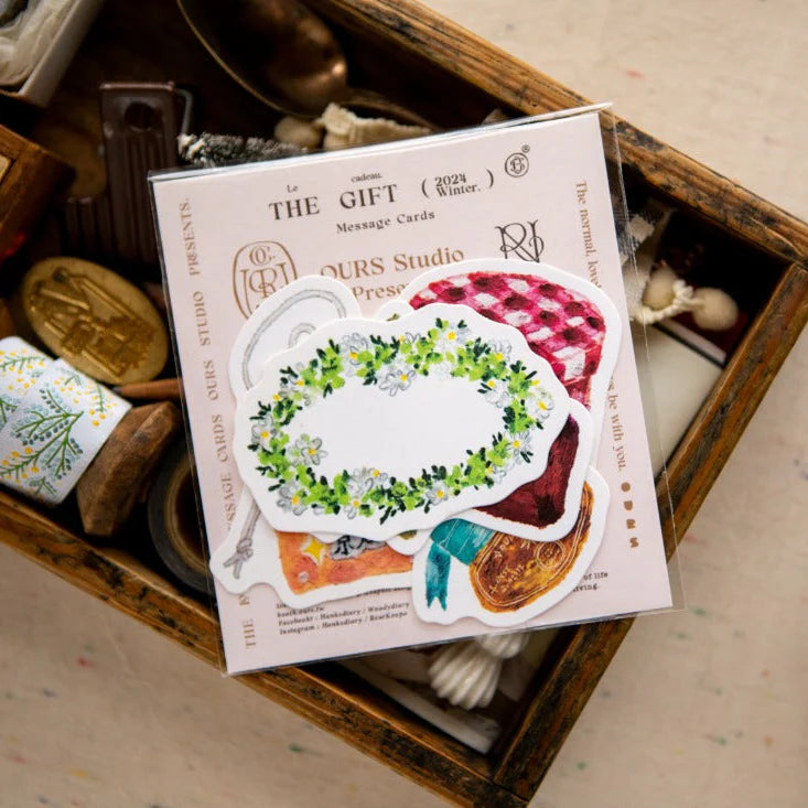 Pack of greeting cards with decorative designs on a wooden surface