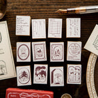 Collection of small printed cards with various designs on a wooden surface.