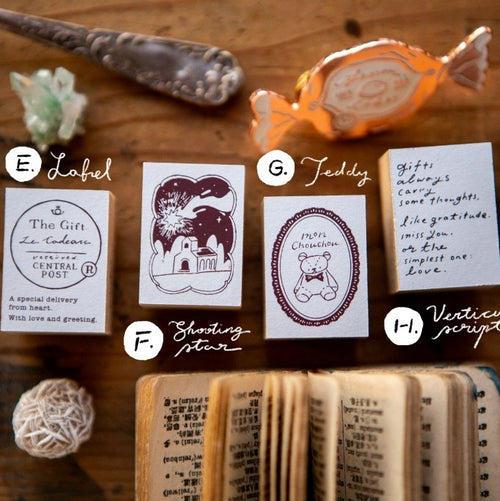 Collection of decorative labels and a small book on a wooden surface
