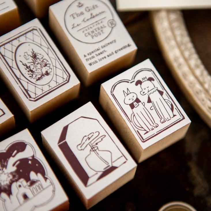 Collection of rubber stamps with cat illustrations on a wooden surface