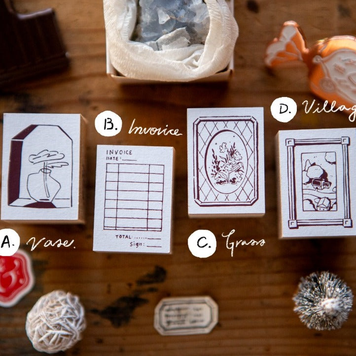 Collection of vintage-style stamps on a wooden surface with decorative items.