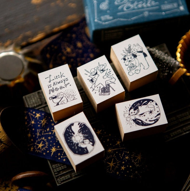 Set of decorative rubber stamps with illustrations and text on a dark background