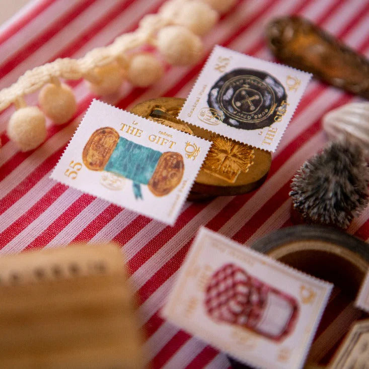 Decorative stamps with festive designs on a red and white striped background