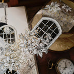 Decorative card with floral and window design on a textured surface