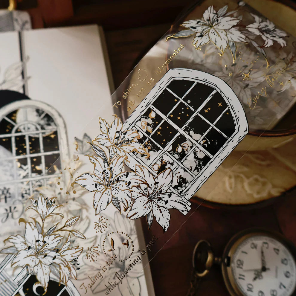 Decorative card with floral and window design on a textured surface
