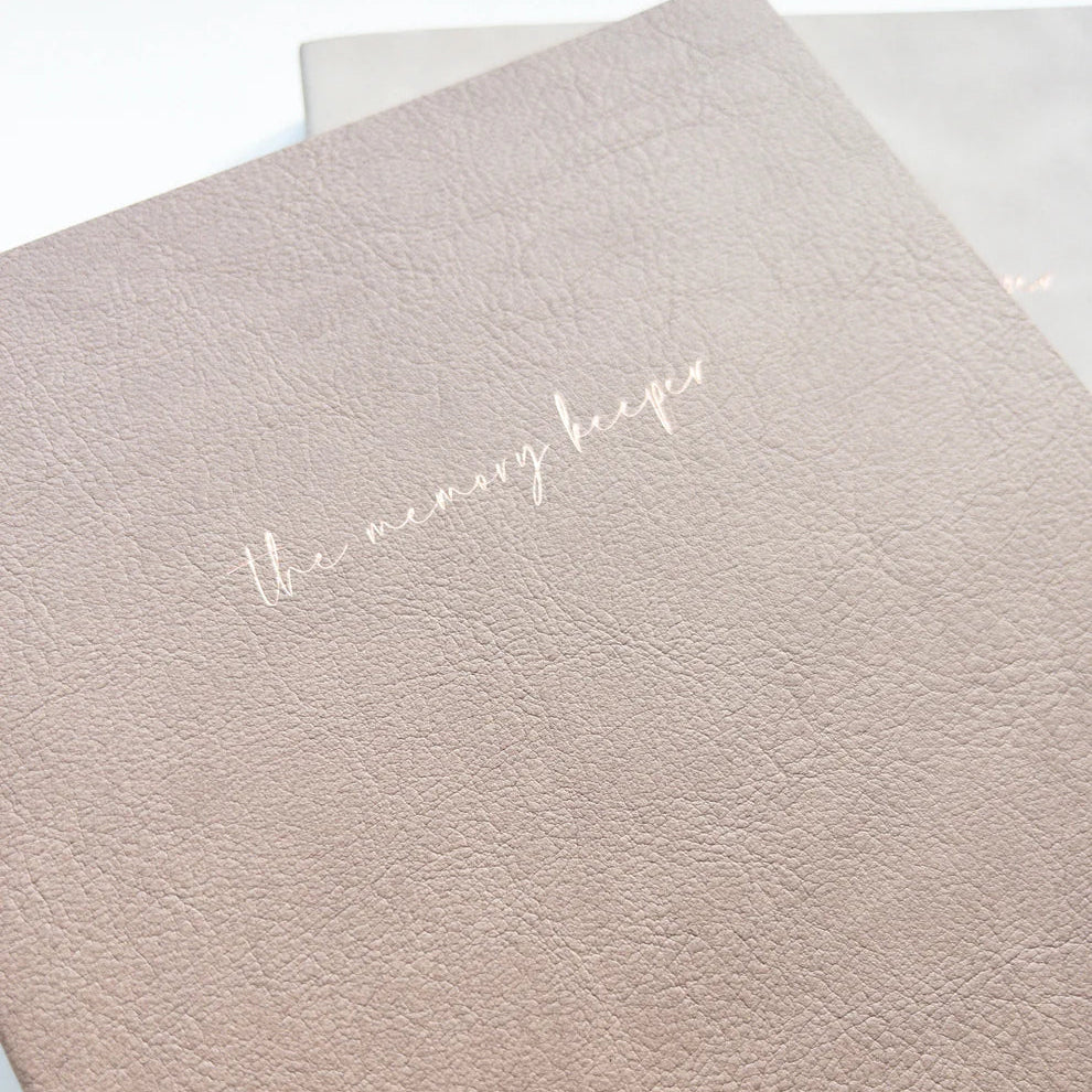 Close-up of The Memory Keeper A5 Journal beige textured cover with elegant script title