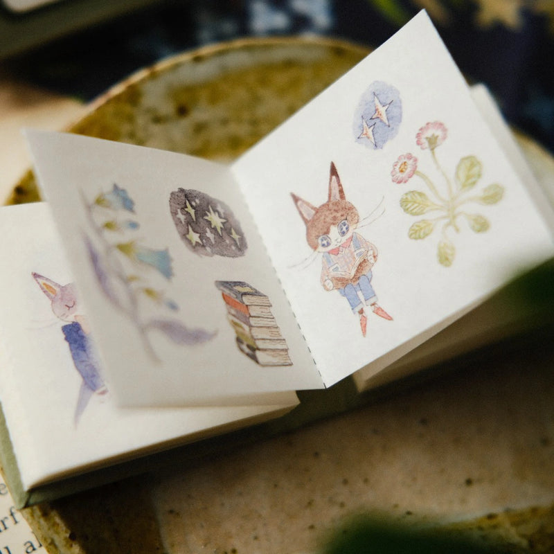 The Wandering Garden sticker book open to fox and nature sticker designs