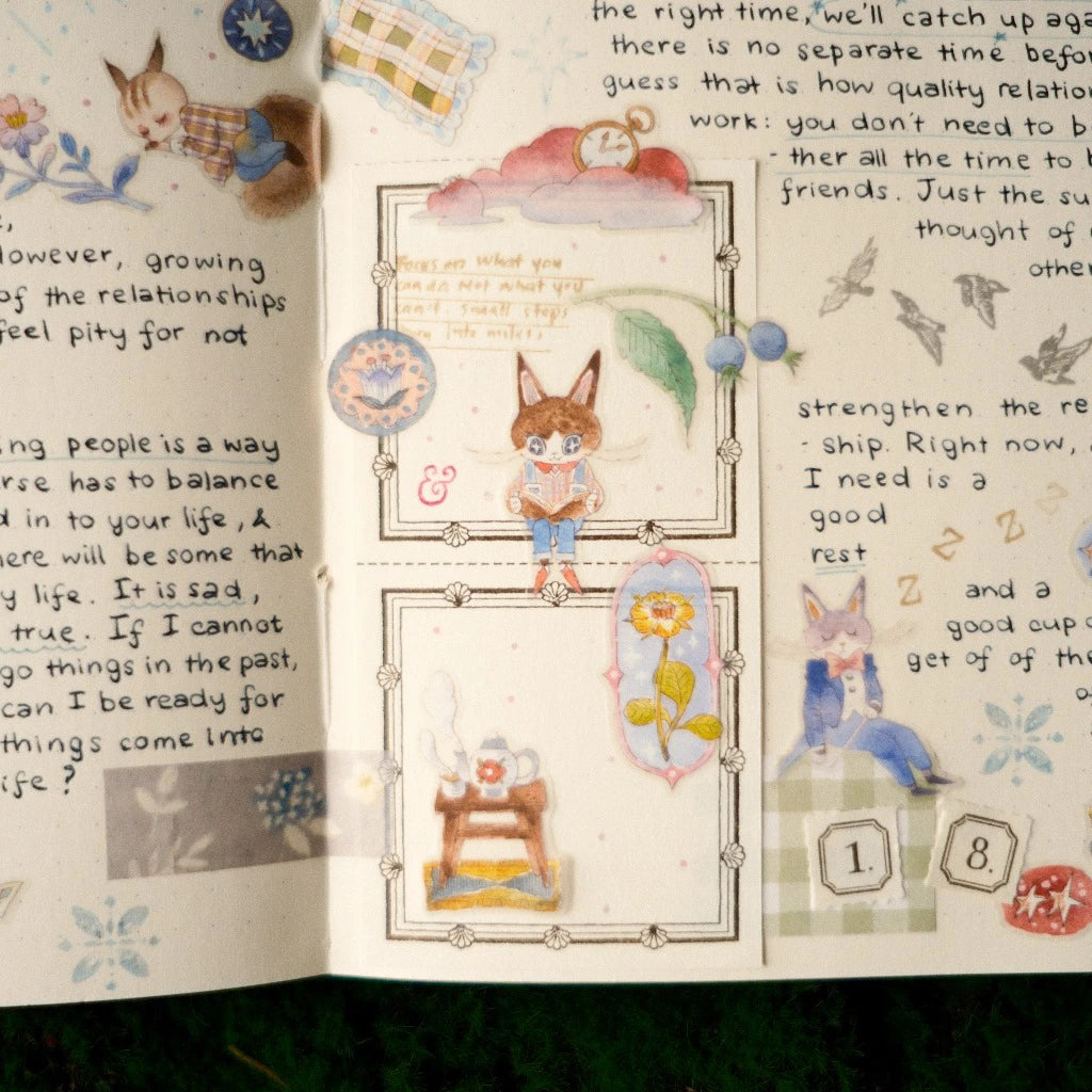 Open book with illustrated fox characters and decorative elements on a white background