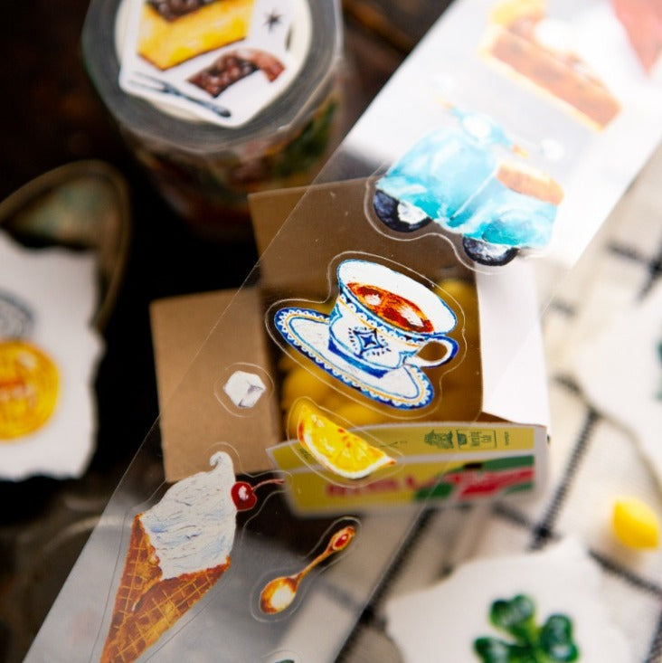Close-up of The Fortune PET Tape food illustrations on clear packaging, soft focus
