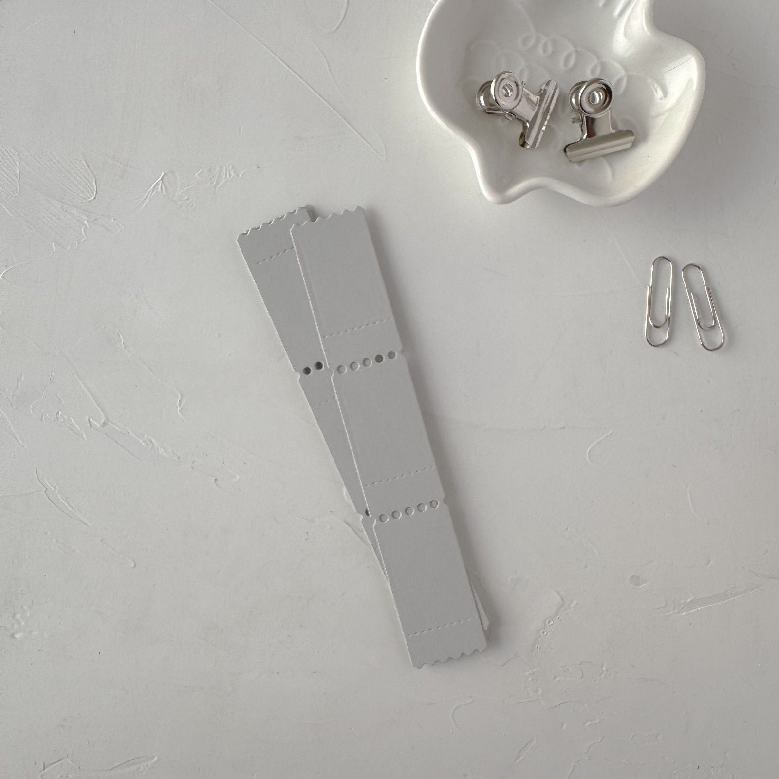 Grey Ticket Card Vol. 2 cards styled together with clips on a light grey background