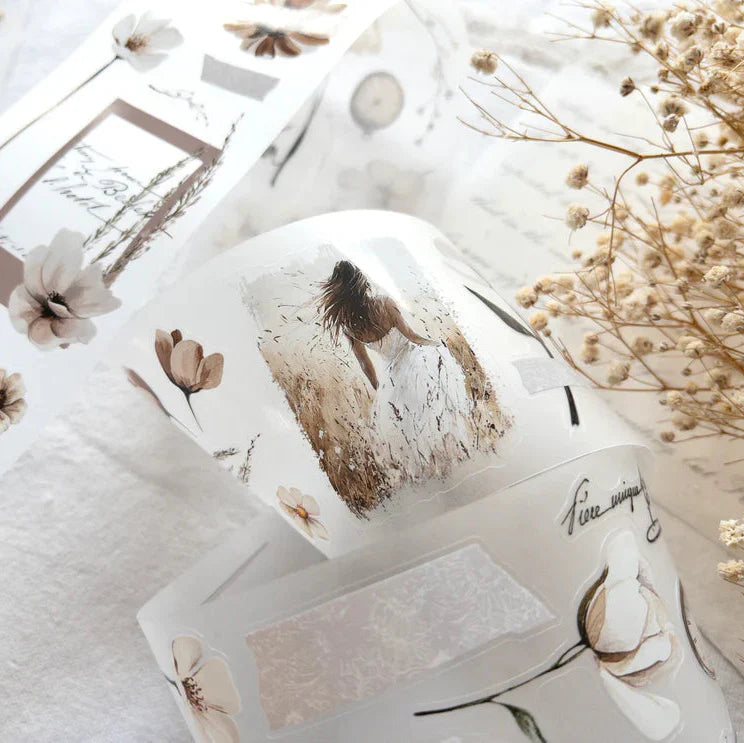 Candle decorated with Timeless PET Tape florals and text on a light background, close-up