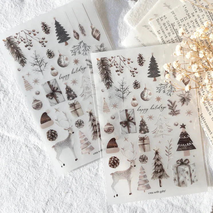 Two Christmas Selection Transfer Sticker sheets with holiday designs on a textured surface
