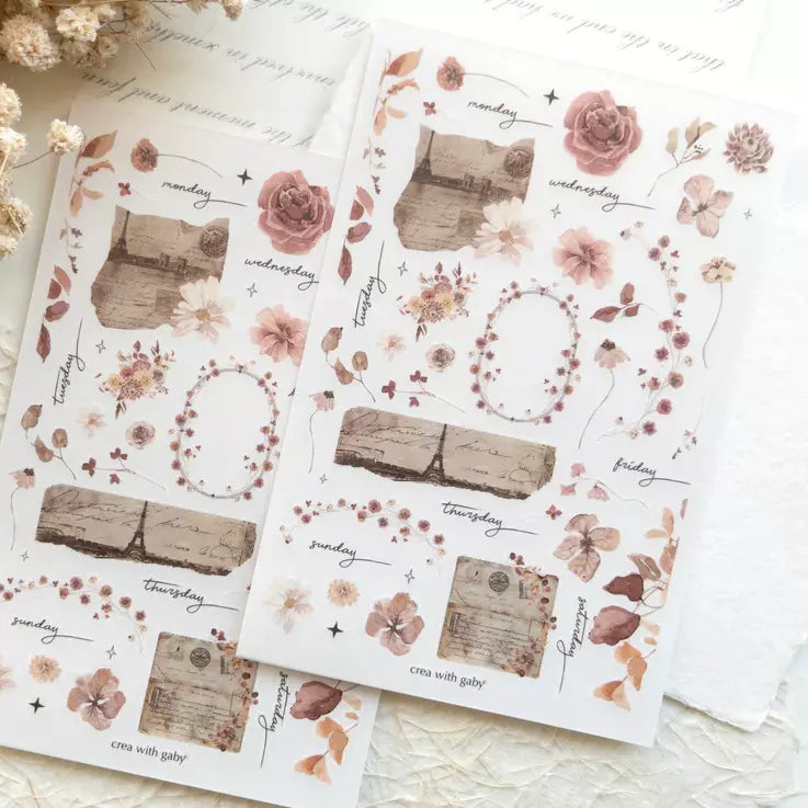 Two Paper Garden Transfer Sticker sheets with floral and botanical designs on a light backdrop