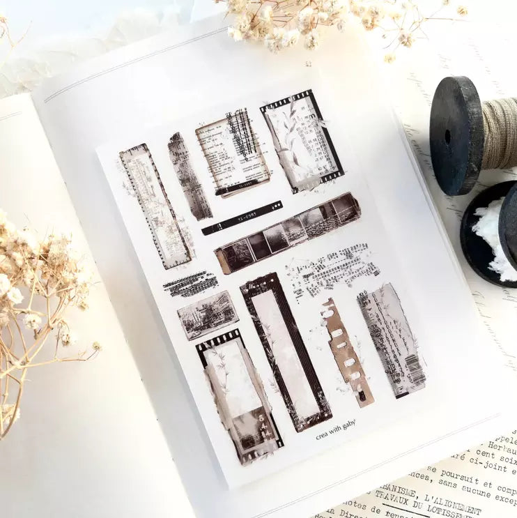 Untold Transfer Sticker sheet of stamp designs with dried flowers and thread spools on white