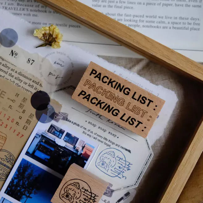 Travel Journaling Series packing list stamp print on a card with deco elements on wood