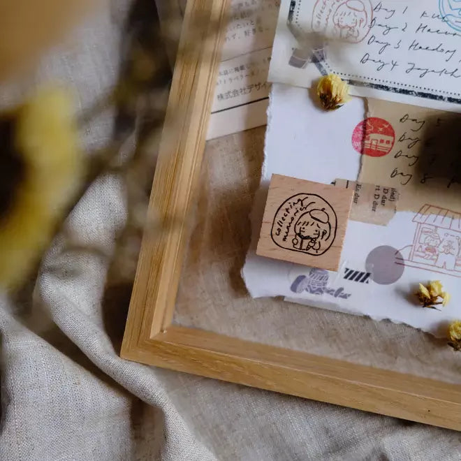 Mini Girls Series travel stamp print in a wooden frame styled on textured fabric