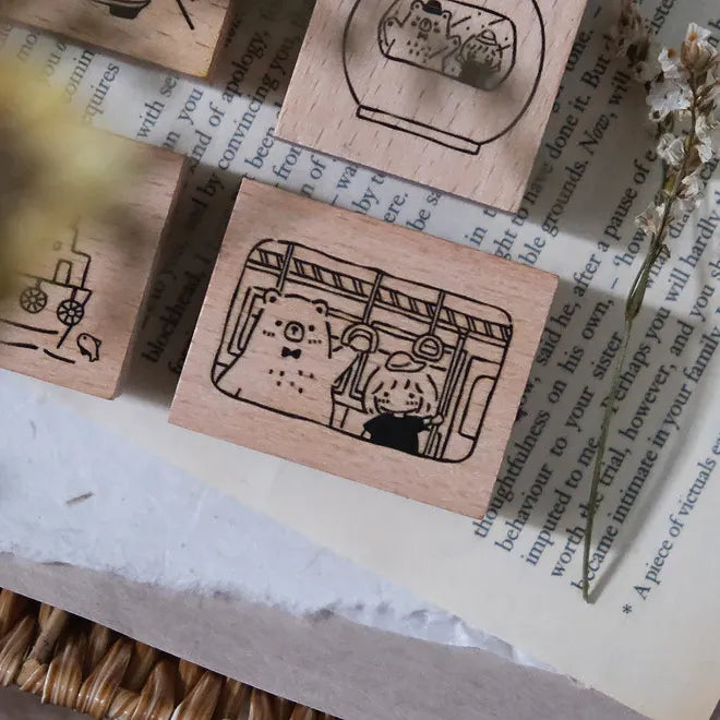 Wooden stamps with cat designs on a textured surface