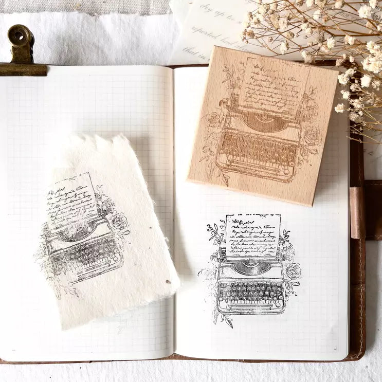 Typewriters Rubber Stamp impressions of vintage machines in an open notebook on white