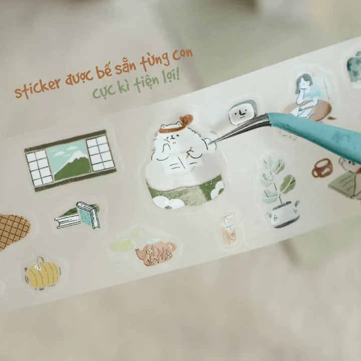 Sheet of Uchi No Wanchan PET Tape pet illustrations held with a blue craft tweezer tool