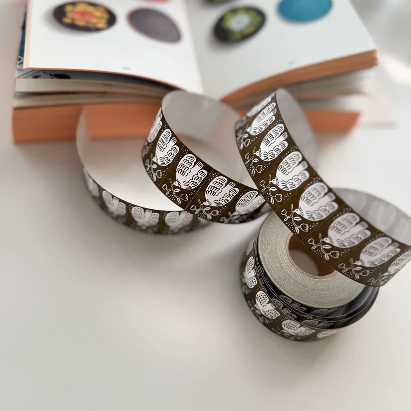 Strip of Umber Label Sticker Tape earthy label pattern displayed on a white surface