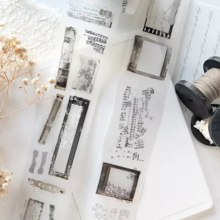 Untold PET Tape black and white stamp designs with dried flowers and a thread spool on white