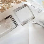 Close-up of a film strip with negatives on a white surface