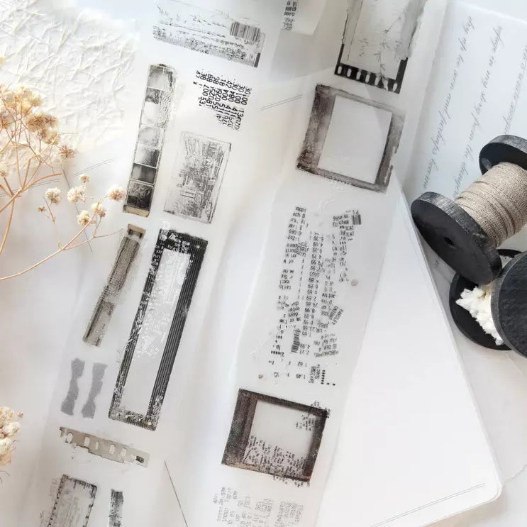 Untold PET Tape monochrome print pieces styled with a thread spool and dried flowers