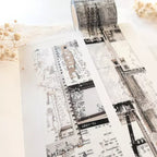 Roll of decorative tape with black and white pattern on a light background
