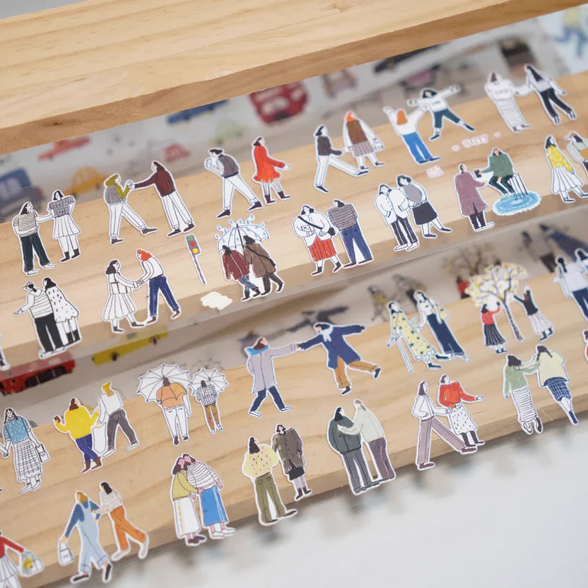 Us Two Sticker Tape figure designs by Wanle Studio styled on a wooden toy on white