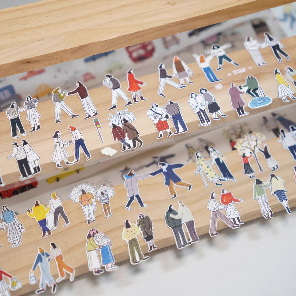 Us Two Sticker Tape colorful figures styled on a wooden toy set on a wooden surface