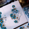 Card with blue and white floral design on a white background