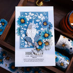 Card with floral design and text on a wooden surface