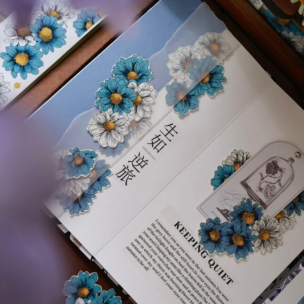 Decorative book with floral designs and text on a wooden surface