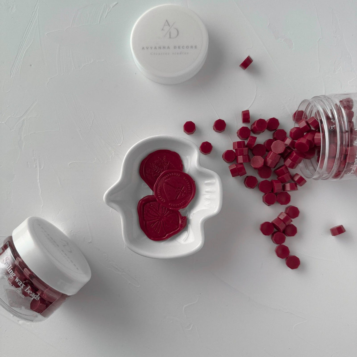 Round Velvet Dream sealing wax seals arranged on a white branded surface, close-up of the rich velvety finish